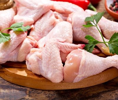 fresh chicken meat on wooden board