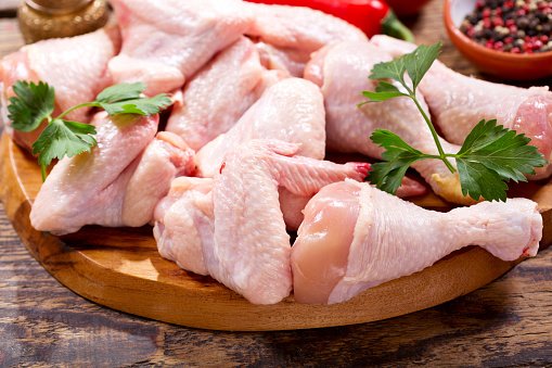 fresh chicken meat on wooden board